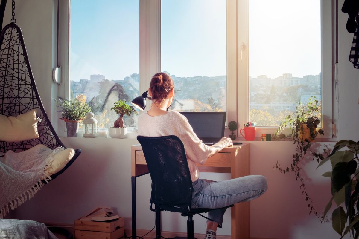 woman on laptop by the window working